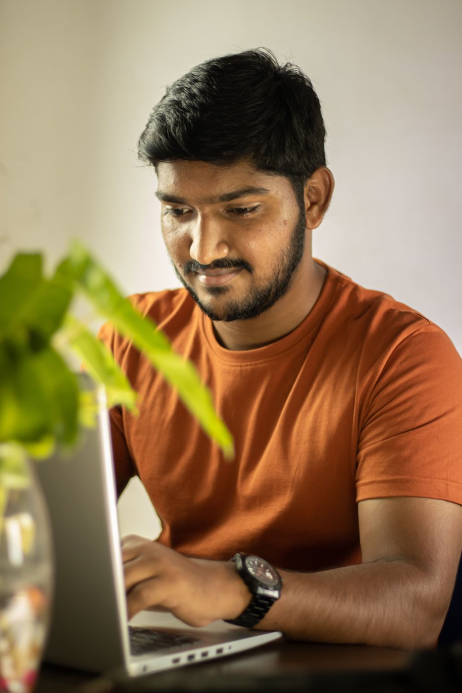A software professional working focused at a laptop